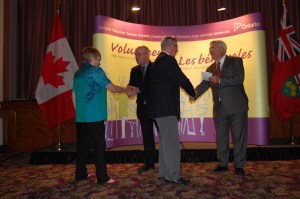 John and Judy receiving their 15-year pins.